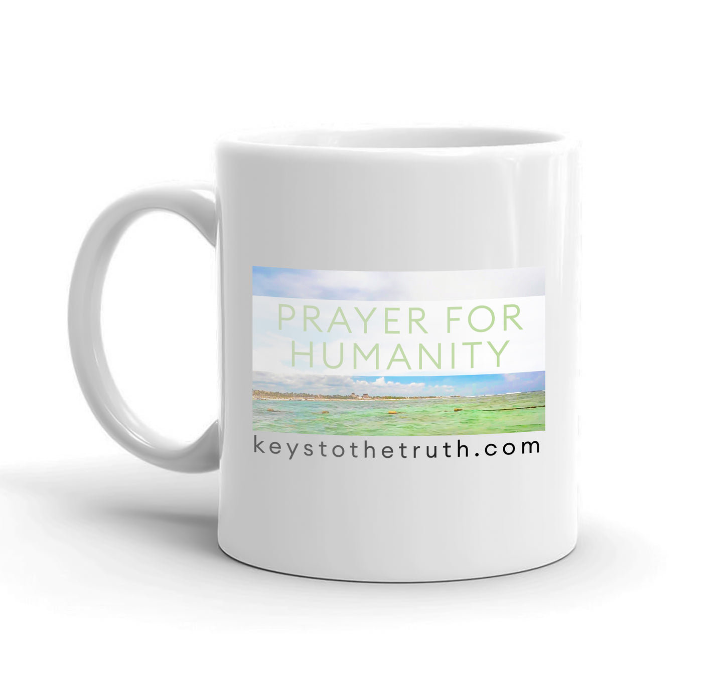 A white mug with the thumbnail print of the youtube video "Prayer for humanity" and the website "keystothetruth.com".